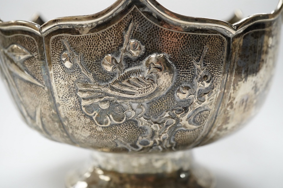 A late 19th/early 20th century Chinese white metal pedestal bowl, decorated with birds and foliage, diameter 15.2cm, 9.5oz. Condition - fair to good.